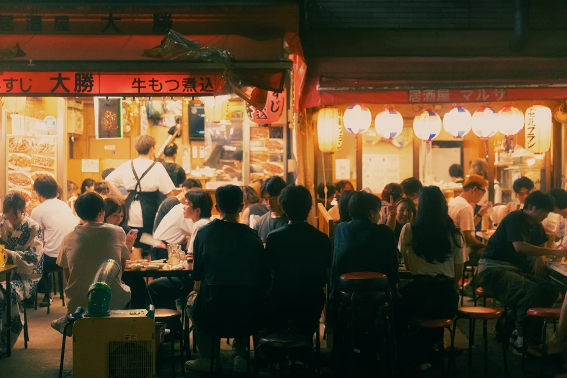 Local street food vendors preparing and serving dishes in a vibrant open market.