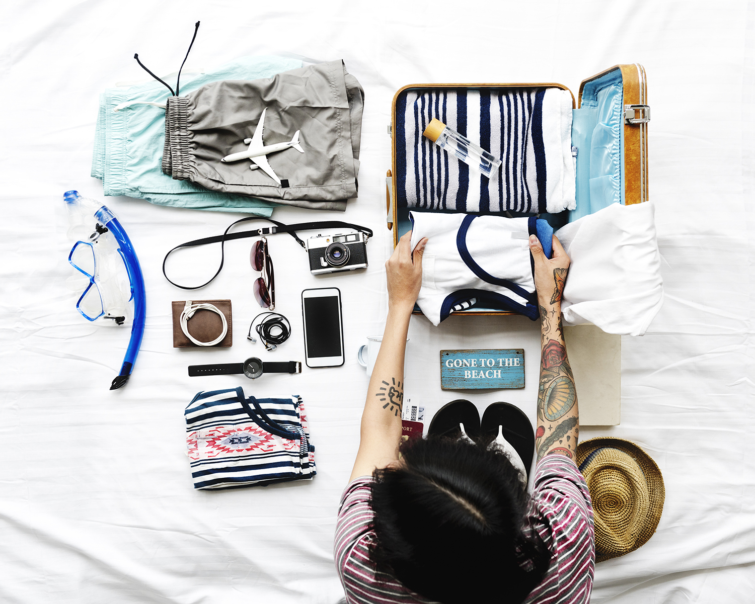 Traveller packing a organised bag with a curated packing list