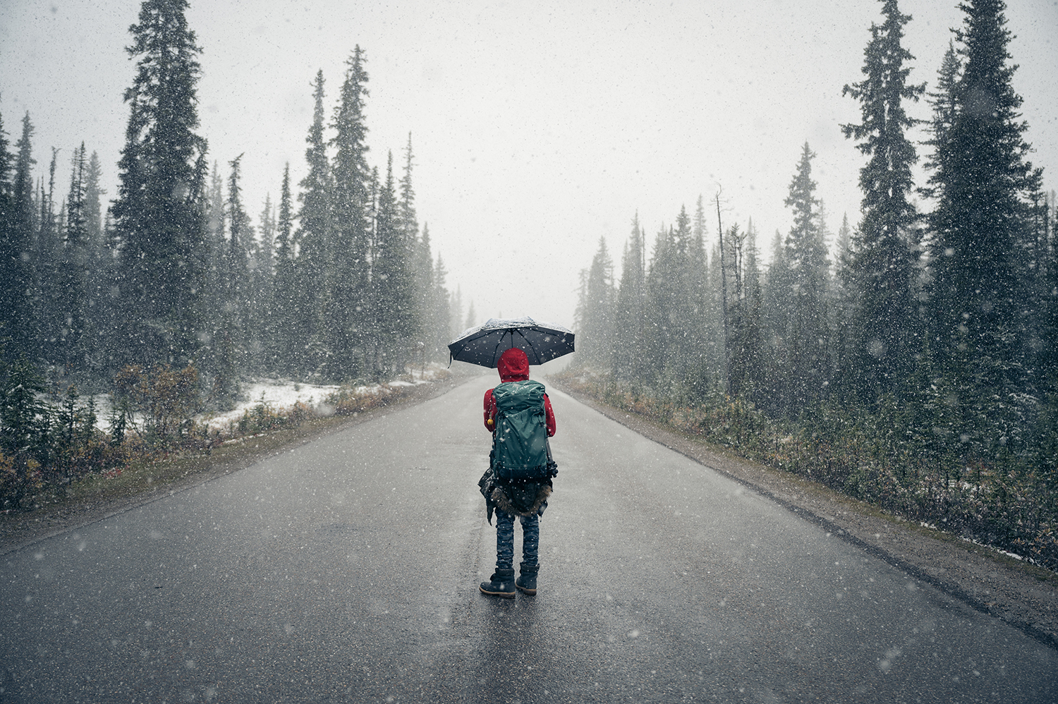 Traveller walking through changing weather conditions